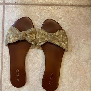 Dressy sandal with gold bow and brown insole.  Bought from ALDO.